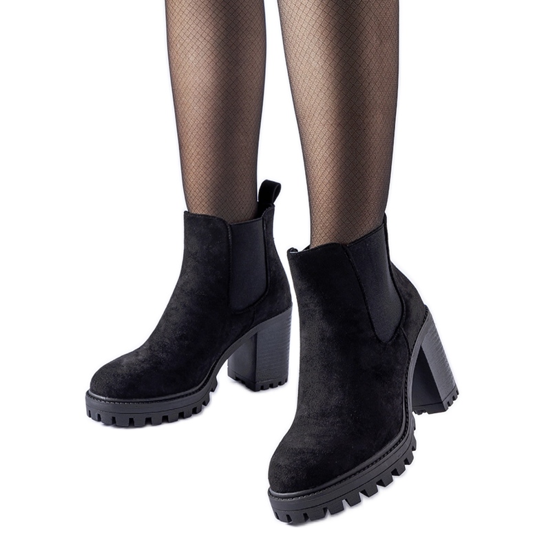 Black ankle boots on a massive Montelparo heel