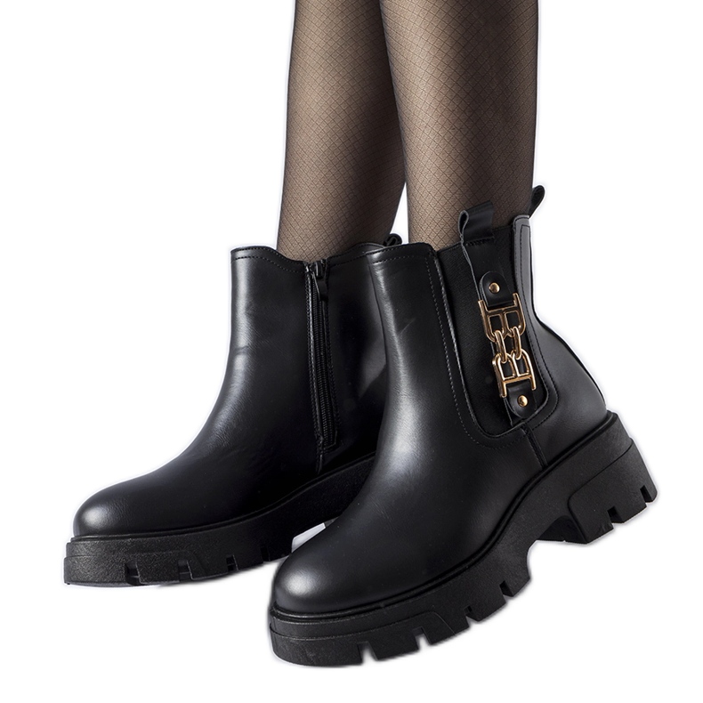 Black massive ankle boots with a decorative Nuovo buckle