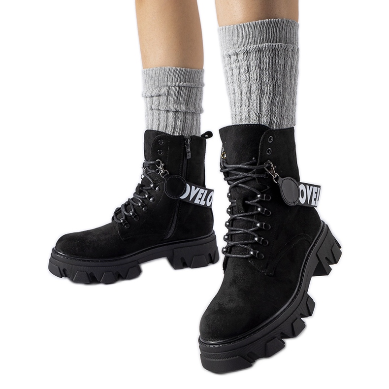 Black ankle boots with a decorative detachable strap