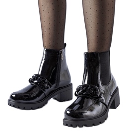 Black patent leather insulated ankle boots with a buckle