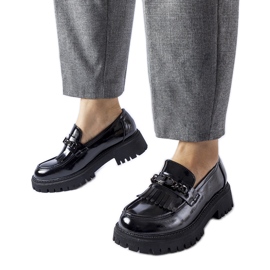 Black patent loafers with a buckle by Agordina