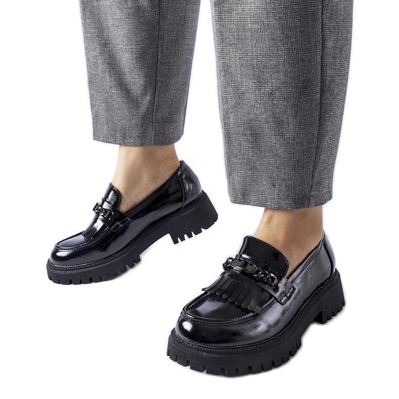 Black patent loafers with a buckle by Agordina
