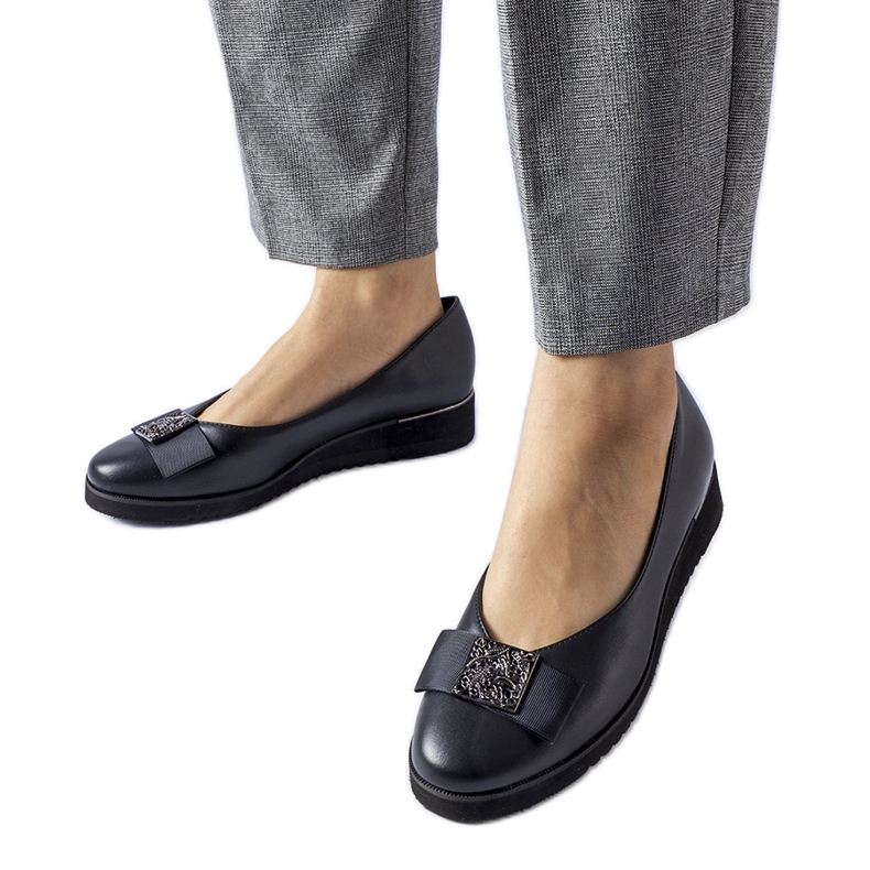 Black ballet flats with a bow on the wedge