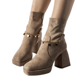 Beige insulated ankle boots with a Saviore pendant
