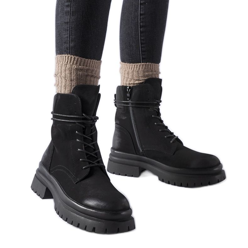 Black Vadnais boots with a worn toe