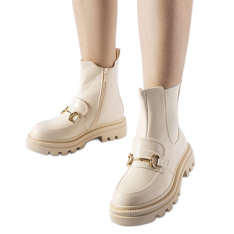 Beige ankle boots with a visible Sailetto protector