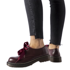 Maroon shoes with a decorative bow from Rodriguez red