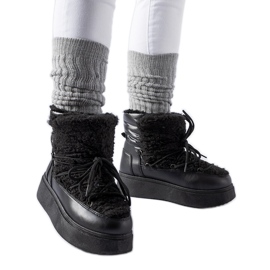 Black snow boots on a massive Elvio platform