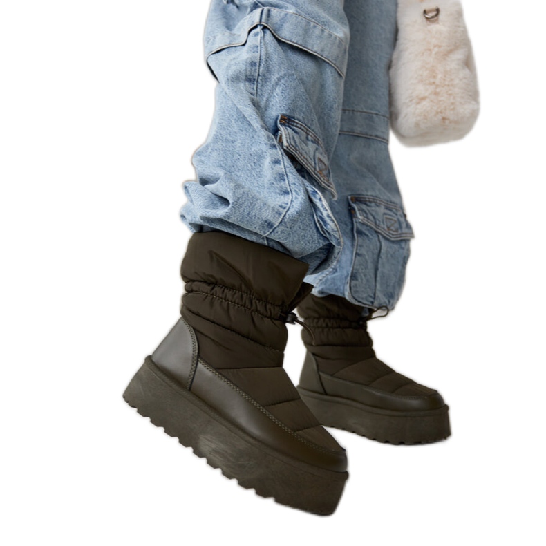 Green insulated snow boots on the Polk platform