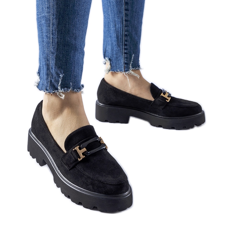 Black moccasins decorated with a Pisa buckle