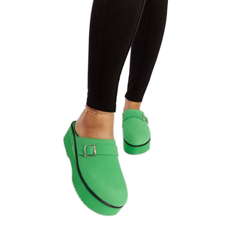 Green clog slides on the Lang platform