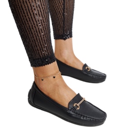 Black moccasins with a decorative buckle by Adila