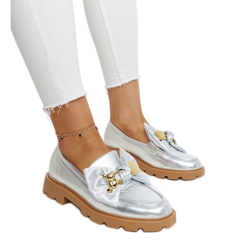 Silver moccasins with a decorative safety pin by Bogumil