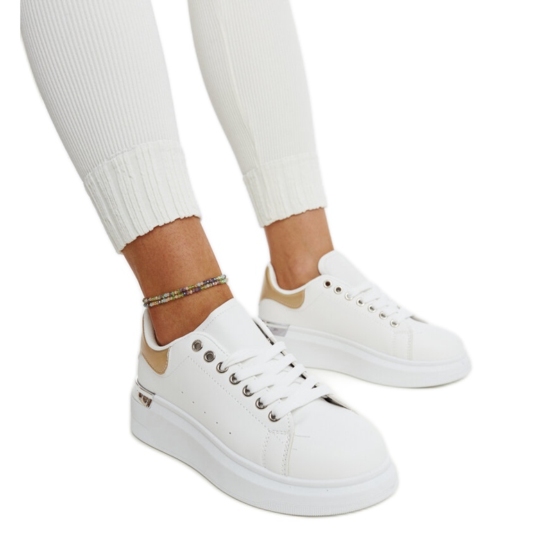 White sports shoes with a gold Meriana insert