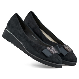 Black suede pumps with a low wedge