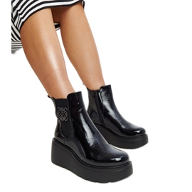 Black insulated patent wedge boots by Sarkisa