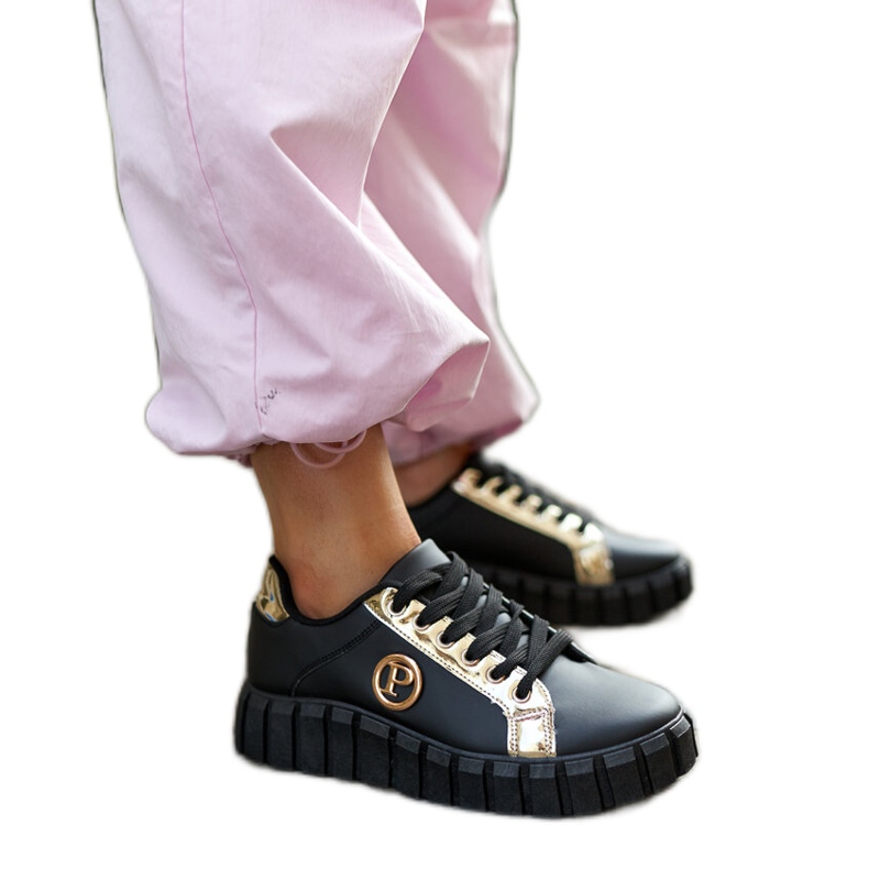 Black and gold sneakers with a massive Bionda sole