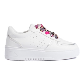 White women's sneakers tied with a ribbon