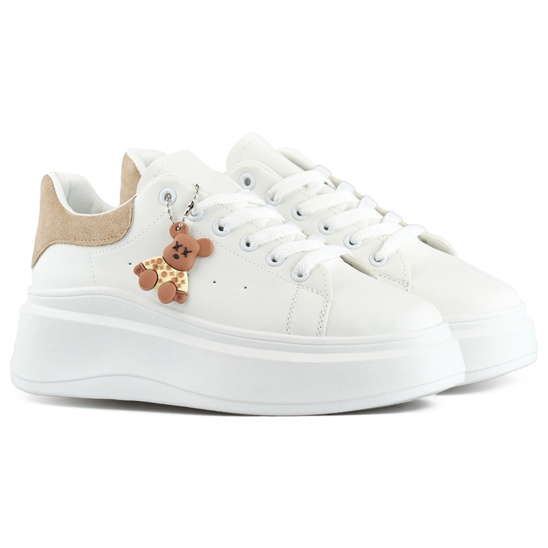 White sports shoes with a thick sole and a beige teddy bear
