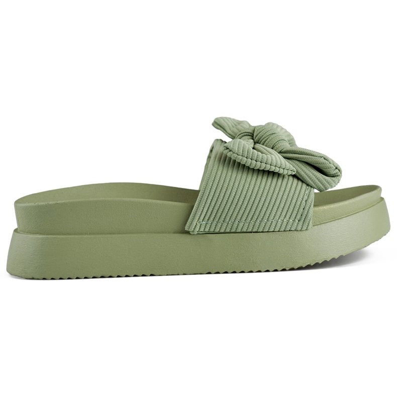 Light green women's slippers with a bow on a thick sole