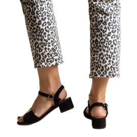 Black low-heeled sandals with a Horner buckle