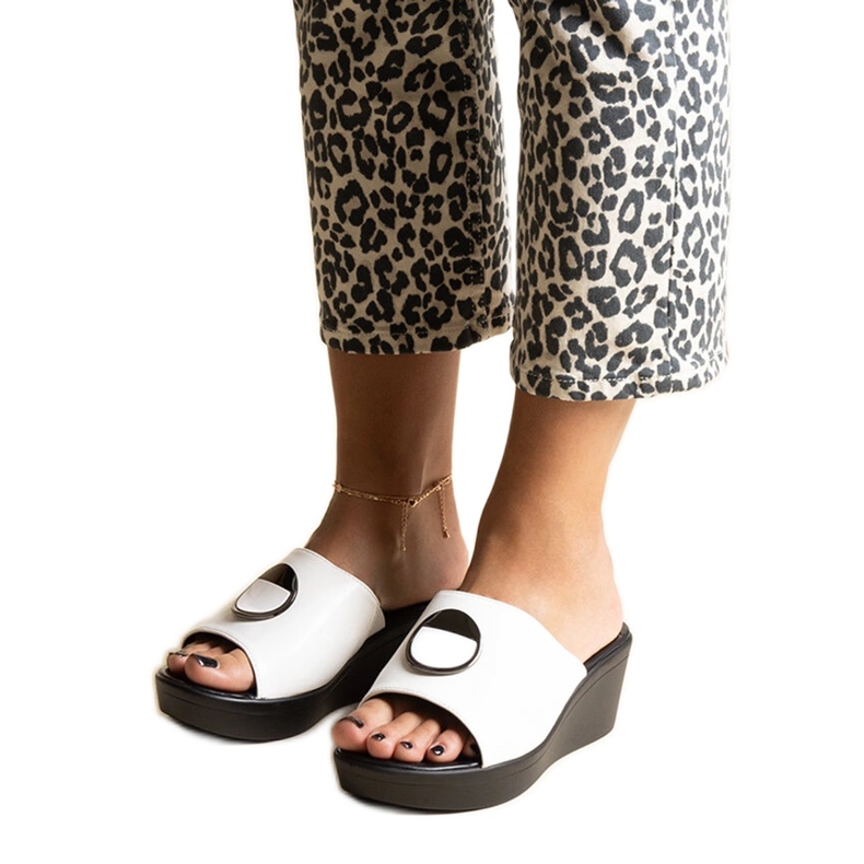 White wedge mules with a Keirenh buckle White wedge mules with a Keirenh buckle