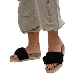 Black flip-flops with a massive Peletra sole