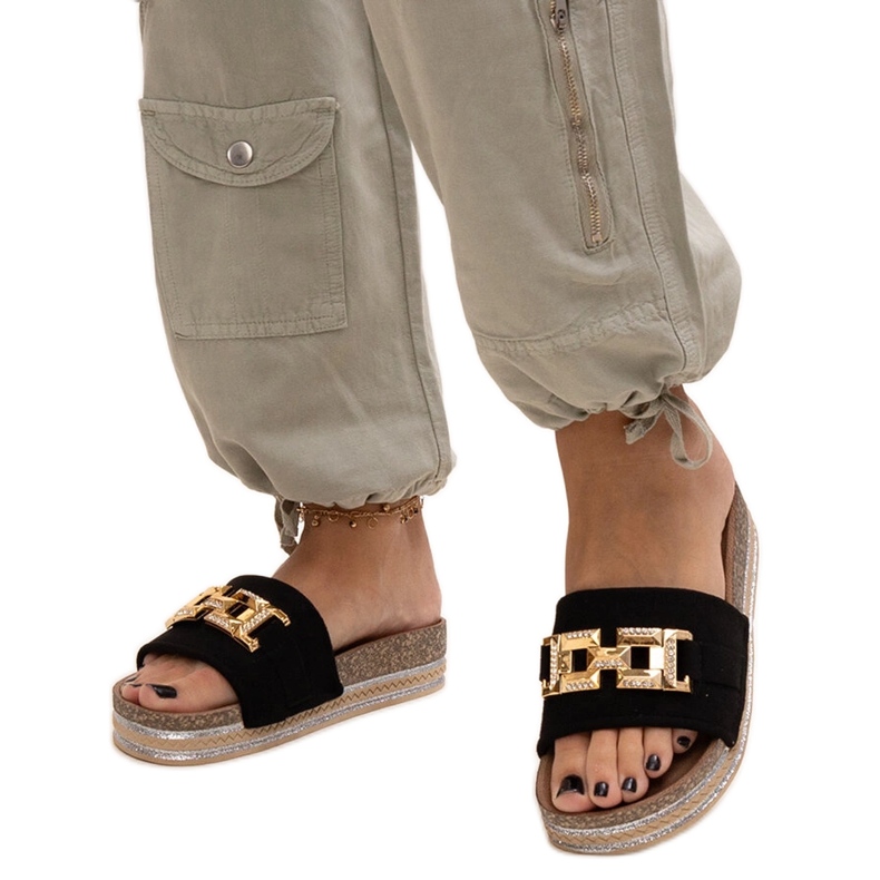 Black flip-flops with a shiny buckle by Niamh