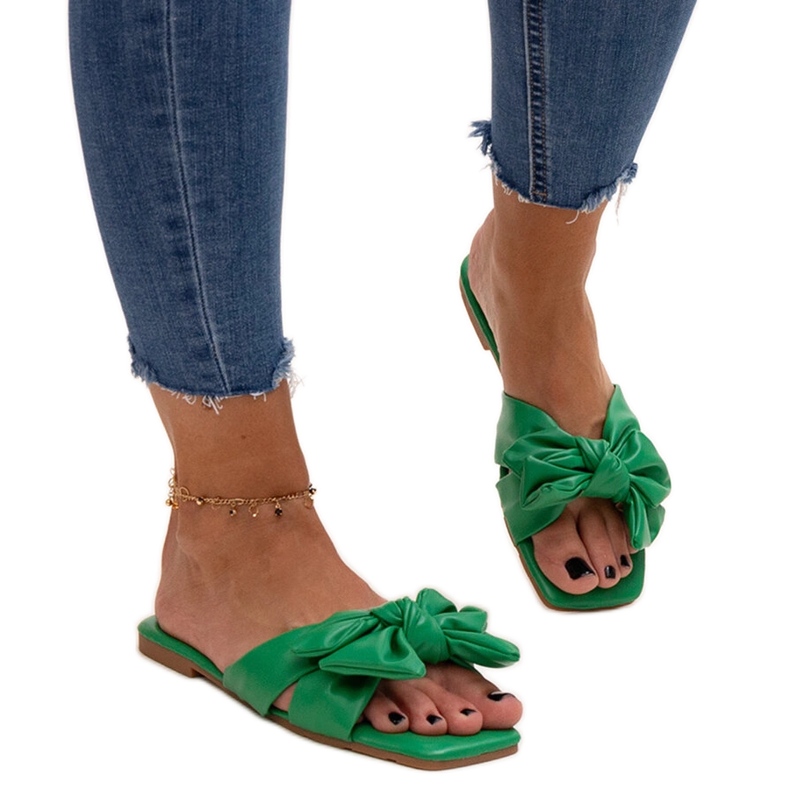 Green flip-flops with a decorative bow by Uwansa
