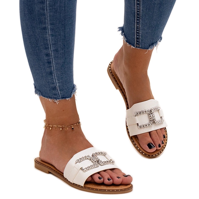 White flip-flops with a decorative buckle by Rochaela
