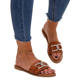 Brown flip-flops with a decorative buckle by Rochaela