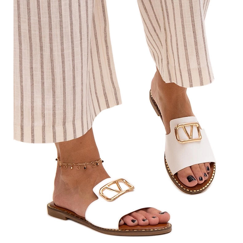 White flip-flops with a Mariza buckle
