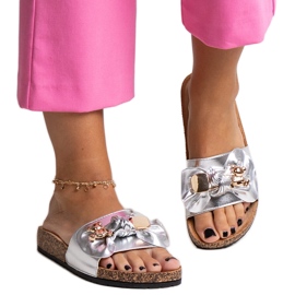 Silver flip-flops with a bow and a Segan teddy bear