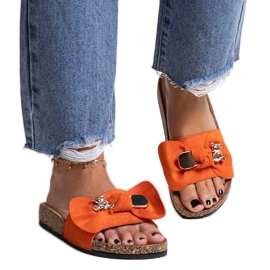 Orange flip-flops with a bow and a Segan teddy bear