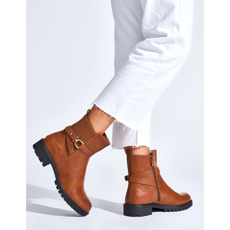 Brown women's ankle boots with a decorative buckle