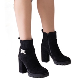 Black high-heeled ankle boots decorated with a Torhia buckle