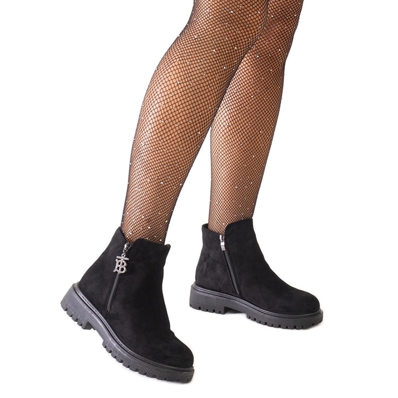 Black ankle boots with a decorative pendant on the Melane eco-suede platform