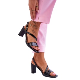 Black lacquered sandals on the post