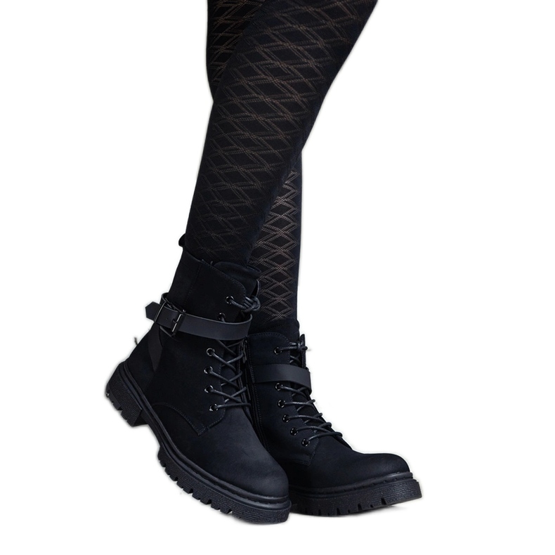 Black insulated hiking boots with abrasions and a Knees strap