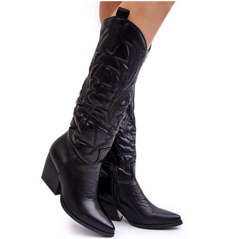 Women's black leather cowboy boots with a high heel