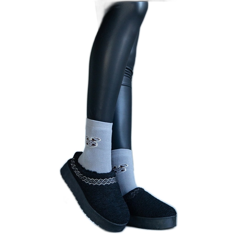 Black platform snow boots with a low upper and an embroidered Greene pattern