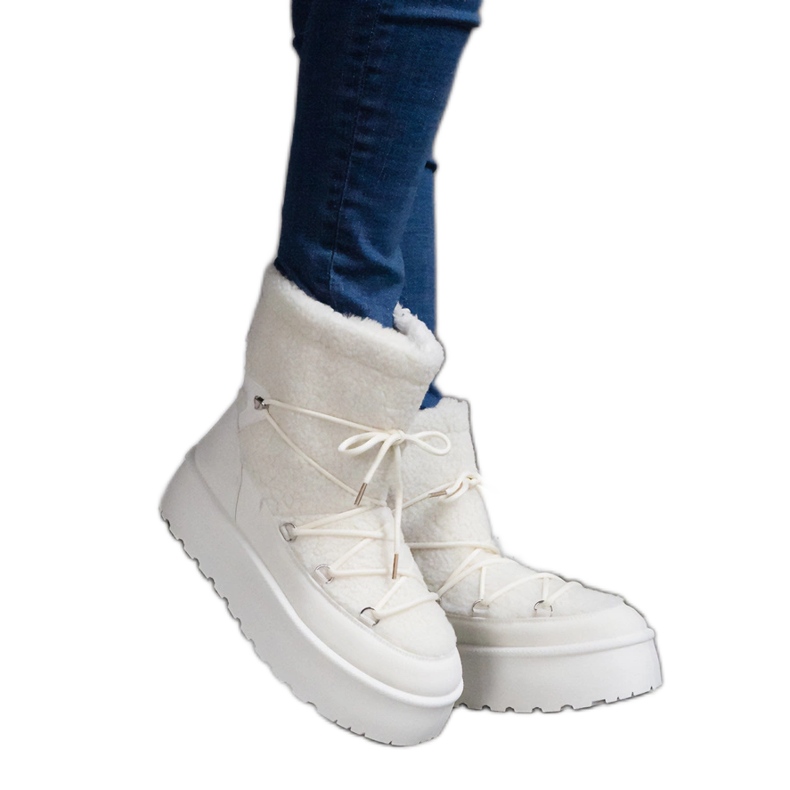 White women's snow boots on the platform, insulated with fur
