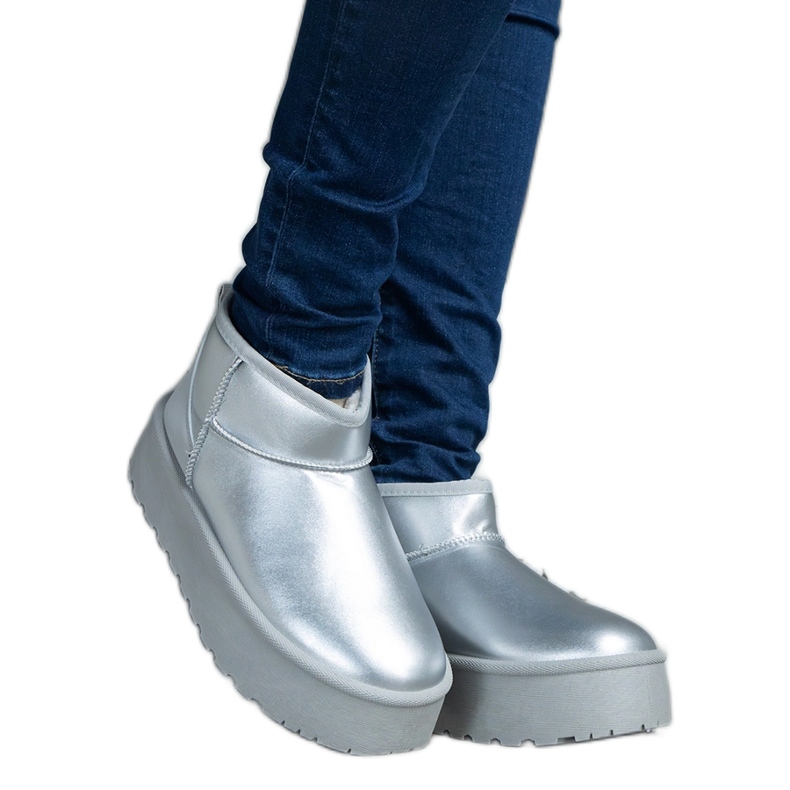 Silver low snow boots on the platform