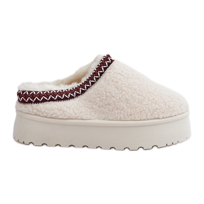 Light beige sheepskin slippers on a platform with fur