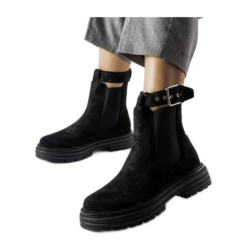 Black ankle boots with a decorative clasp