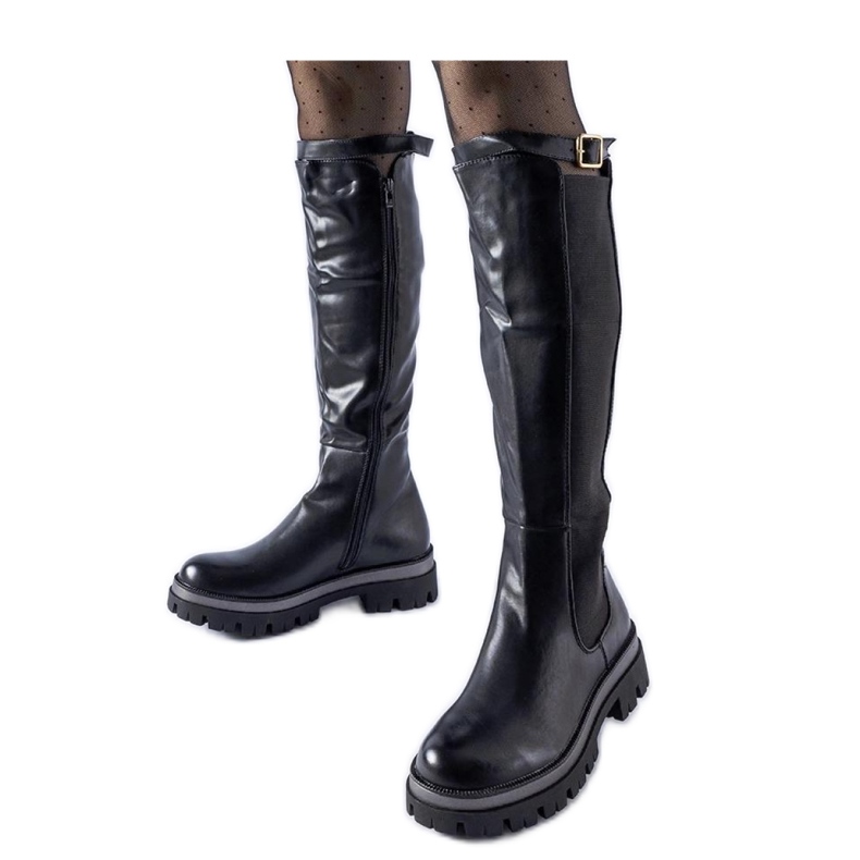 Black massive boots with a decorative belt from Stuart - Solea