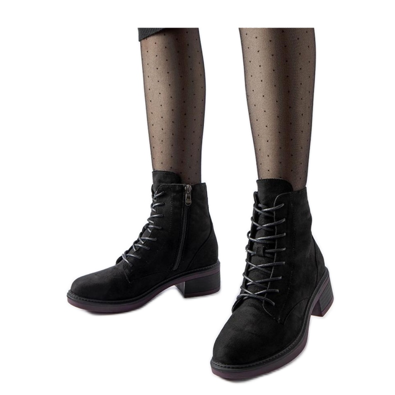 Black classic ankle boots with a purple sole