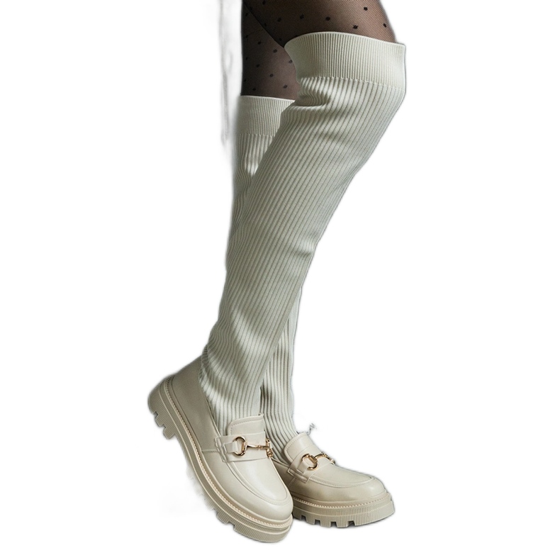 Light beige boots with a flexible upper and a flat heel