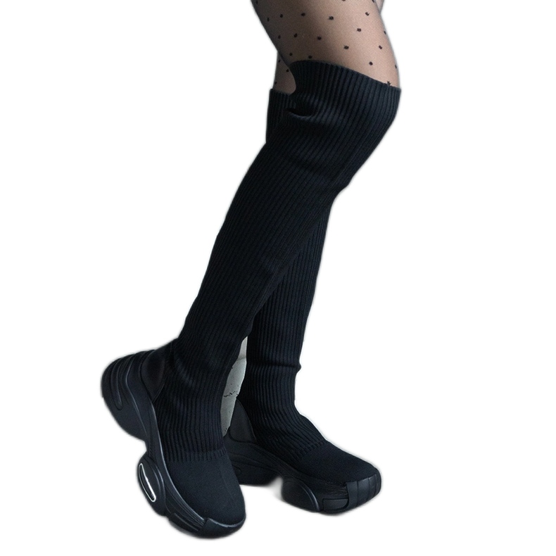 Black slip-on boots with a flexible upper and a massive sole