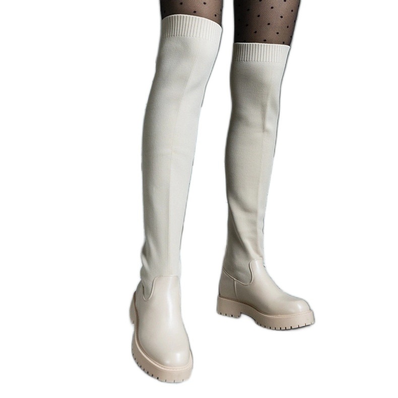 Light beige boots with a flexible upper and a flat heel